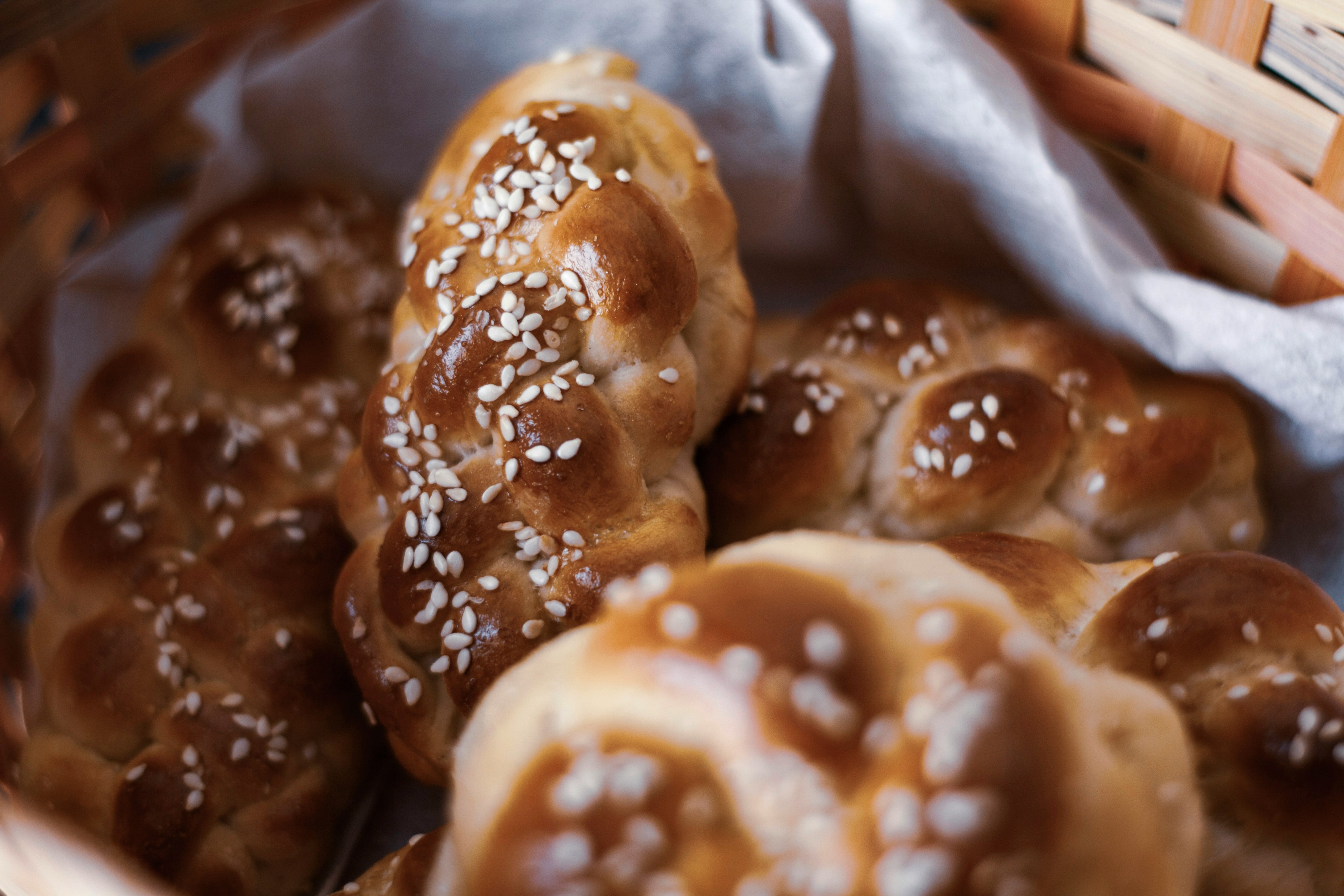 Freshly baked challah bread on a rustic table, Photo by Svetlana B on Unsplash